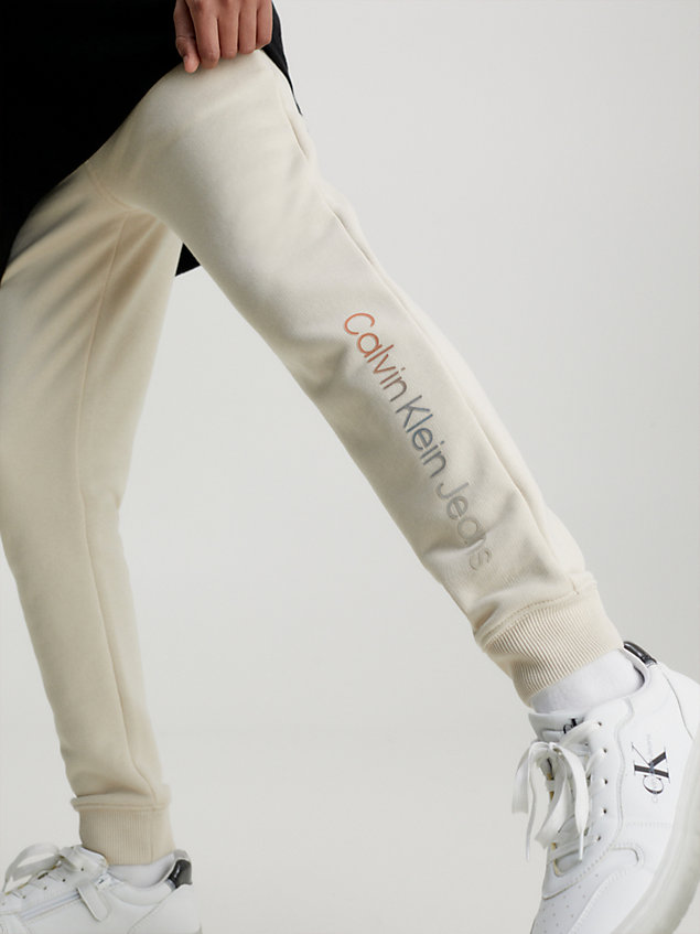beige spodnie dresowe unisex z logo dla kids unisex - calvin klein jeans