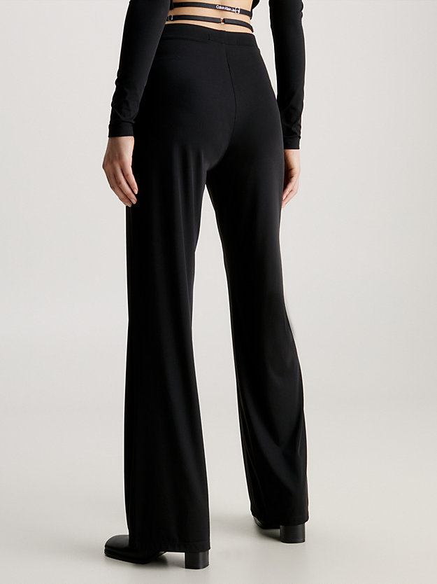 ck black dżersejowe rozszerzane spodnie z ozdobnym paskiem dla kobiety - calvin klein jeans