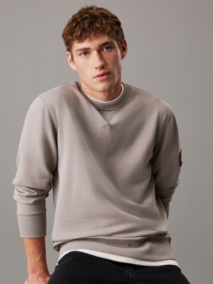 muted grey cotton terry badge sweatshirt for men calvin klein jeans