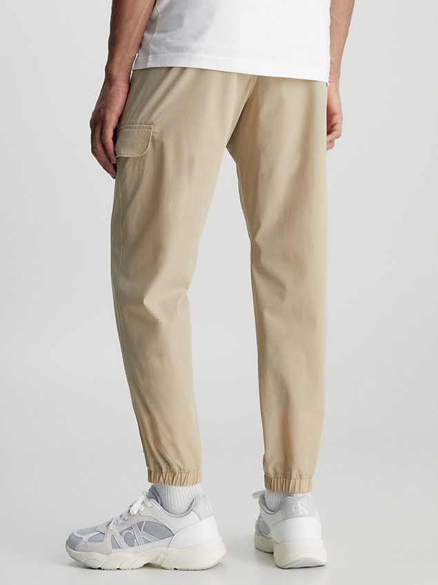 beige recycled nylon tapered cargo pants for men calvin klein jeans
