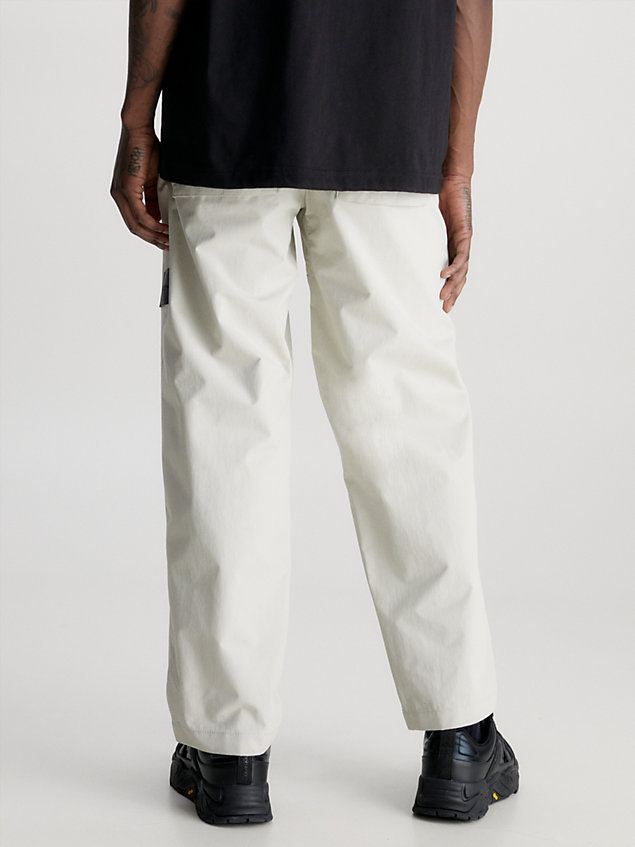 beige spodnie z prostymi nogawkami z nylonu technicznego dla mężczyźni - calvin klein jeans