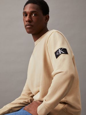 pale khaki washed cotton badge sweatshirt for men calvin klein jeans