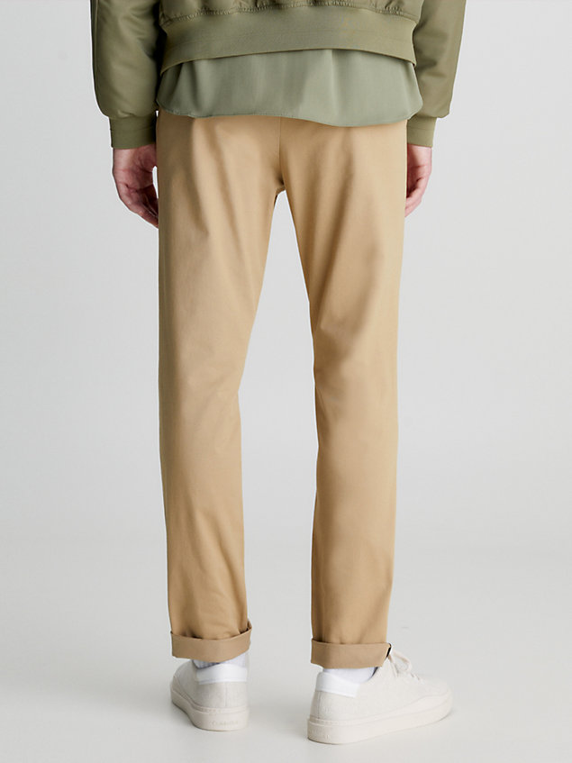 beige slim belted chino trousers for men calvin klein