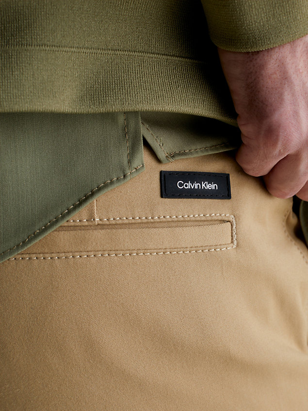 beige slim belted chino trousers for men calvin klein