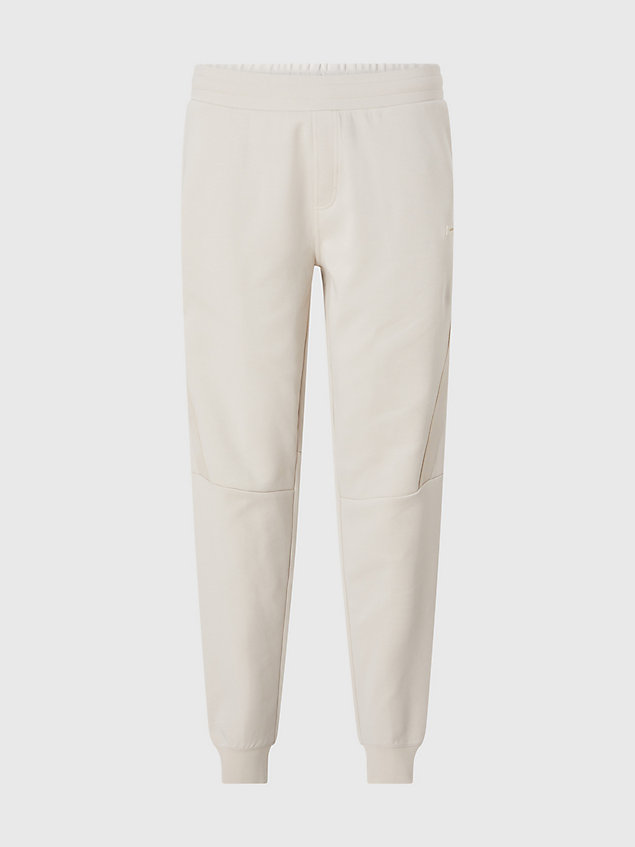 beige swobodne spodnie dresowe z logo dla mężczyźni - calvin klein