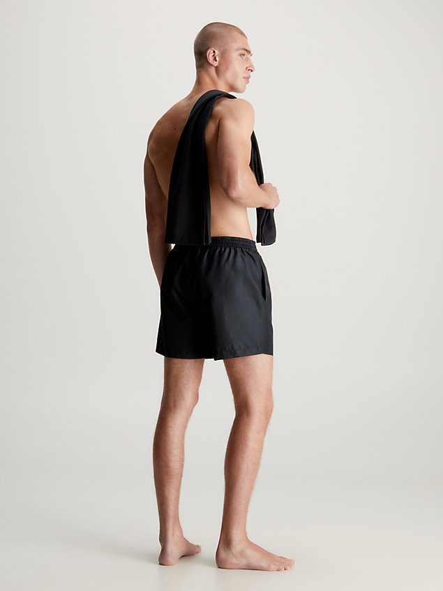 black swim shorts and towel gift pack for men calvin klein