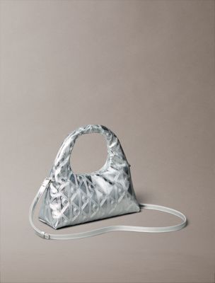 silver metallic puffer emblem logo metallic mini bag for women calvin klein