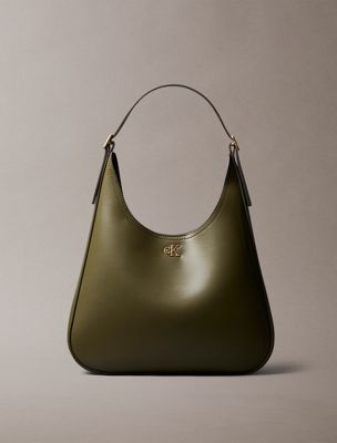 green monogram hardware curved shoulder bag for women calvin klein