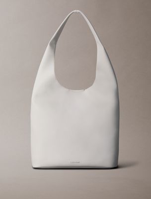 white pebble grain slouchy curved bag for women calvin klein